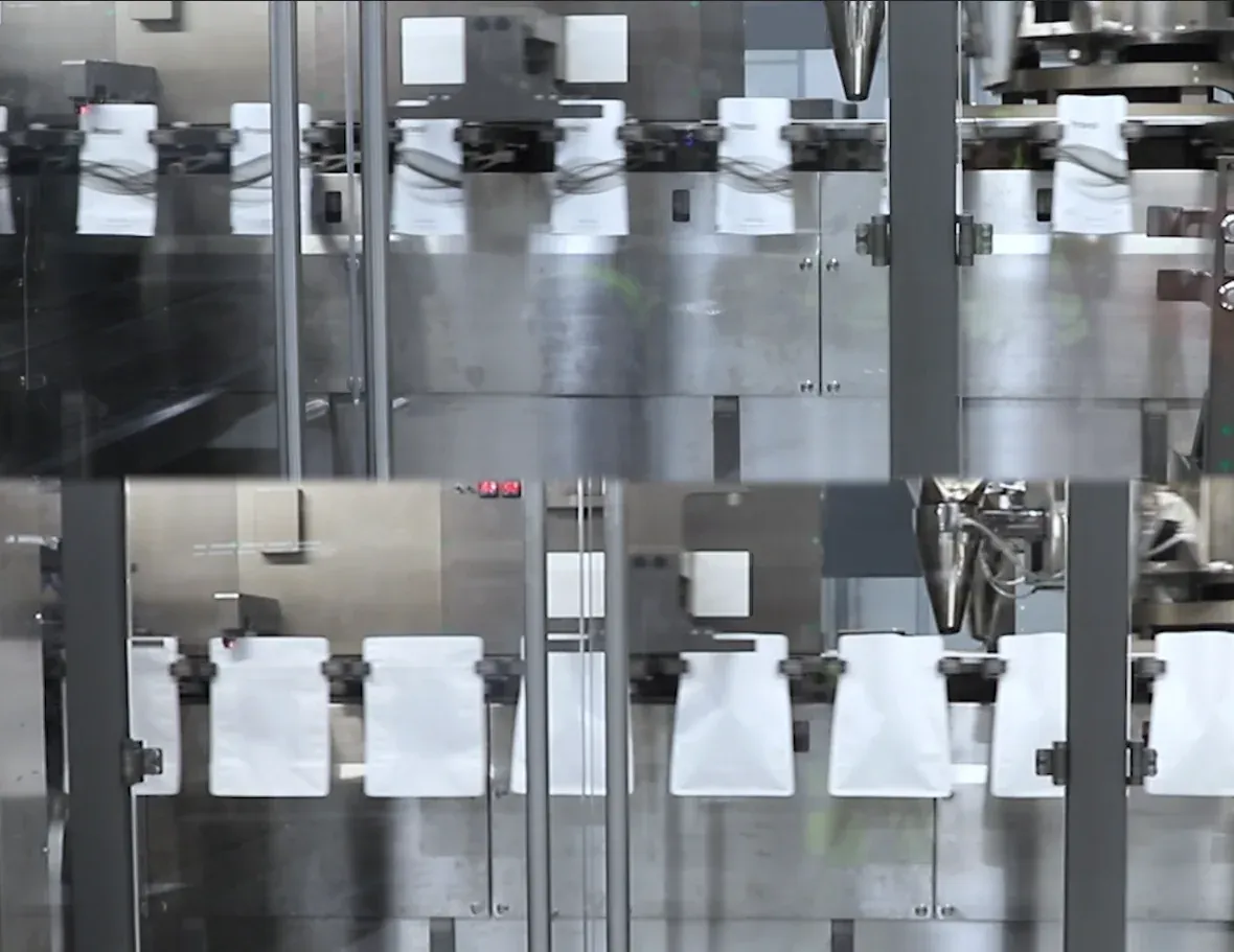 Formed pouches moving towards filling (two views)